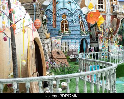 Enchanting Easter scene featuring whimsical fairy-tale houses adorned with vibrant decorations, selective focus. Joyful composition brings the essence Stock Photo