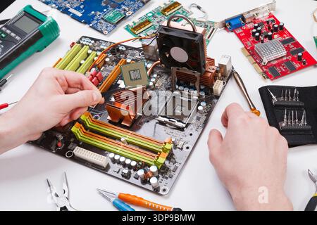 Technician plug in microprocessor to motherboard Stock Photo