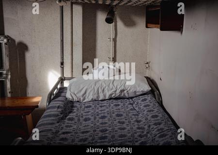 A white "Dixie cup" sailor hat sits centered on a fluffy white pillow Stock Photo