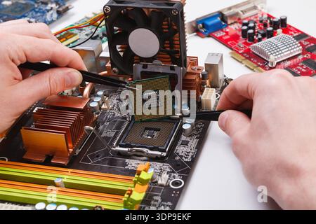 Technician plug in microprocessor to motherboard Stock Photo