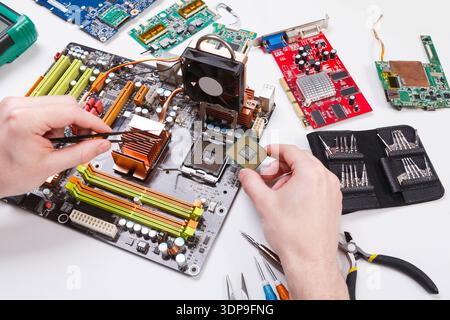 Technician plug in microprocessor to motherboard Stock Photo
