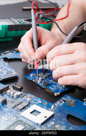 Laptop motherboard testing in service center Stock Photo