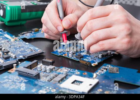 Laptop motherboard testing in service center Stock Photo