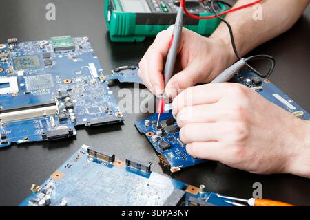 Laptop motherboard testing in service center Stock Photo