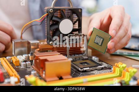 Technician Installs a New CPU on a Computer Motherboard During a Hardware Upgrade Stock Photo