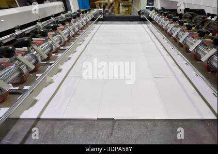 Cutting A4 paper in a large printing facility during the production process for commercial printing tasks Stock Photo