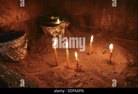 Burning wax candles in an orthodox church in the sand Stock Photo