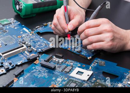 Laptop motherboard testing in service center Stock Photo