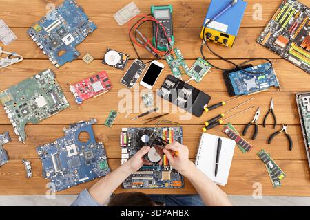 Circuit Board Repair Workshop With Tools and Parts on the Workbench Stock Photo