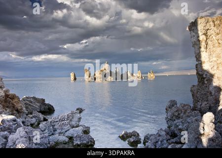 Stormy clouds hover above Mono Lake's unusual limestone Tufa formations at sunset in the Eastern Sierras Stock Photo