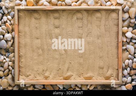 Beach sand in wooden tray on sea pebbles Stock Photo