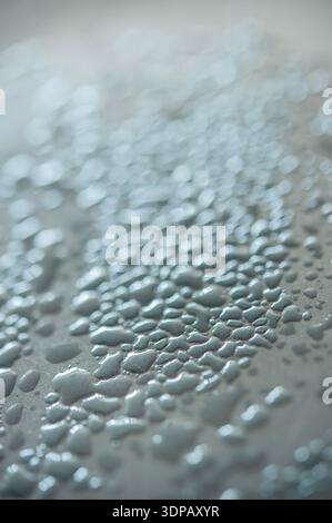 Macro view of water droplets forming a soft abstract texture with reflective highlights and shallow depth of field Stock Photo