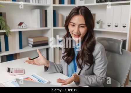 Professional businesswoman reviewing performance reports in a modern office, analyzing results and planning next steps to improve strategy, productivi Stock Photo