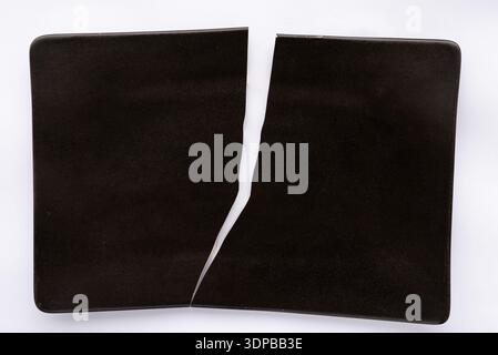 Broken black plate Stock Photo