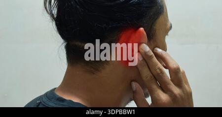 man with earache, ear pain and otitis. Health problems concept Stock Photo