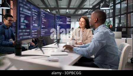 African American Software Engineer Leading Diverse Team In Computer Security. Stock Photo
