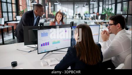 Analyzing Financial Data, A Diverse Group Of Analysts In Office. Diverse Team Of Analysts In Training Stock Photo