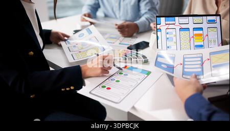 Diverse Young Businesspeople Discussing Marketing Strategy For Mobile Application Development. Stock Photo