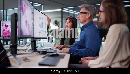 Experienced Graphic Designer And Young Web Developer Discussing Project Collaboration. Stock Photo