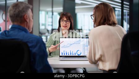 Happy Client Consults With Financial Advisor For Tax Planning Advice. Stock Photo