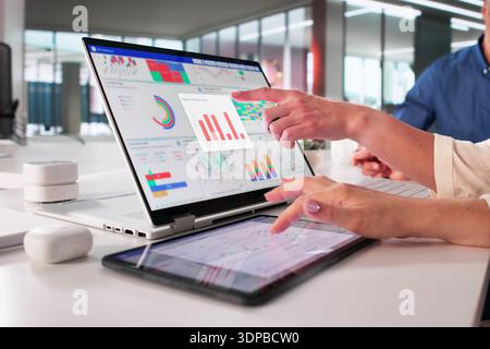 Digital Analytics Team Analyzing Business Data On Interactive Tablet Dashboard. Stock Photo