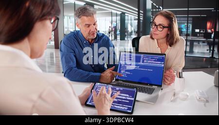 Businesswoman And Programmer Collaborating On Software Design At Office Meeting Stock Photo