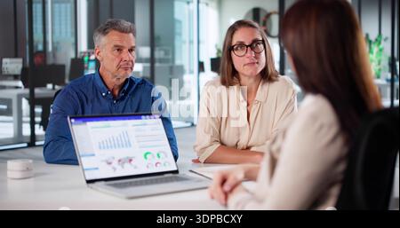 Financial Advisor Meeting With Happy Client For Tax Planning Advice Depicts A Diverse Group Stock Photo