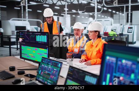 Man And Woman Managing SCADA Software For Industrial Automation Plant Stock Photo