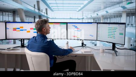 Man Using Scheduling Software To Manage Business Calendar Events Efficiently. Stock Photo