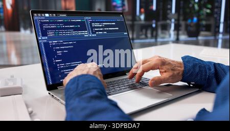 Male Programmer Writing Code For Web Software Engineering Project During Office Hours. Working On Security Measures Stock Photo