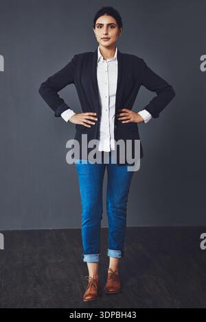 Confident, studio and portrait of business woman with professional style, pride and serious for career. Fashion, entrepreneur and person on dark Stock Photo