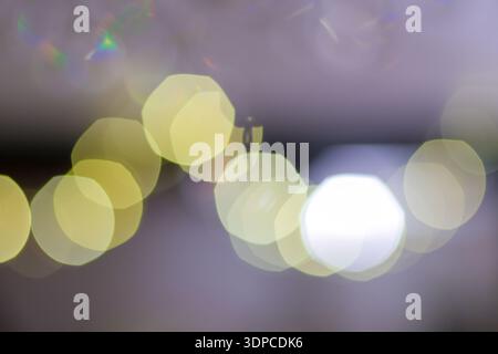 Soft focus bokeh light circles creating abstract pattern with rainbow lens flare effects Stock Photo