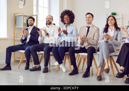 Business office diversity people group, team union applauding sitting in a line, multiracial workers Stock Photo