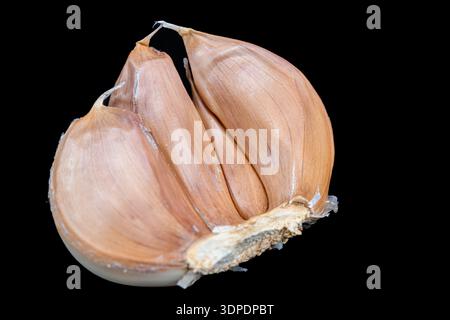 Garlic cloves isolated on black background Stock Photo
