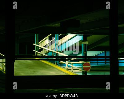 Empty Multi-Level Parking Garage Ramp With Neon Green Lighting and No Entry Sign, Tübingen, Germany Stock Photo