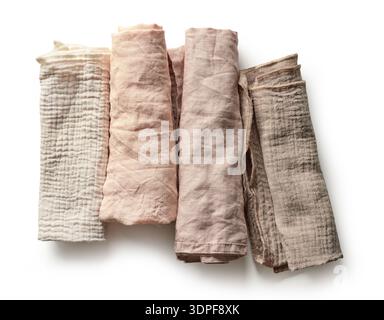 Top view of four rolled linen napkins in soft pastel colors isolated on white background. Minimal and clean composition suitable for table setting, ho Stock Photo