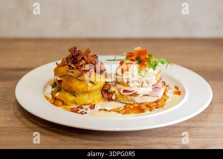 Gourmet breakfast plates with eggs benedict and savory pumpkin stack Stock Photo