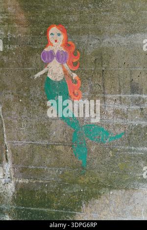 Colourful cartoon mermaid street art mural on concrete wall in Folkestone underpass. Folkestone,England Stock Photo