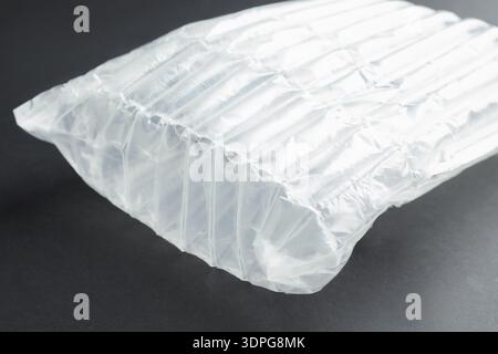 Transparent air buffer packaging on black background, closeup Stock Photo