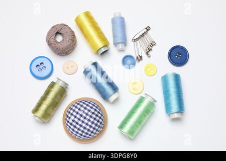 Flat lay composition with different sewing supplies on white background Stock Photo