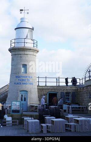 Harbour Arm Lighthouse in Folkestone, Kent, inscribed with Ian Hamilton Finlay's "Weather is a Third to Place and Time" Stock Photo
