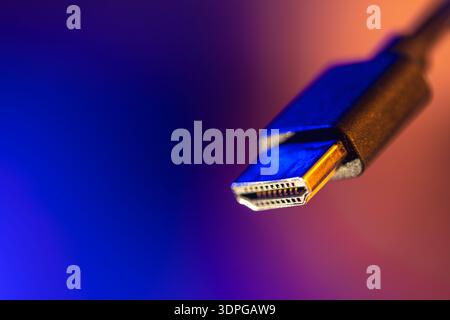 Hdmi plug in focus on blue copyspace. Neon connection. Stock Photo