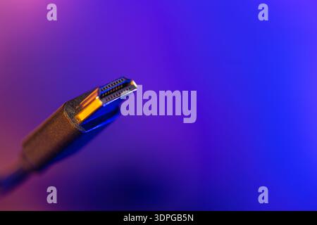 Hdmi cable on vibrant blue background. Side view connector. Stock Photo
