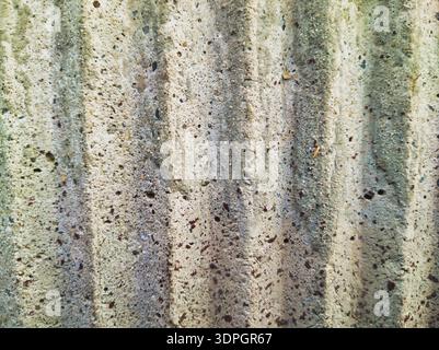 A restorative, rhythmic study of a brutalist concrete wall at Pongratz Gergely ter. Deep vertical ridges and speckled stone textures offer a grounded, Stock Photo