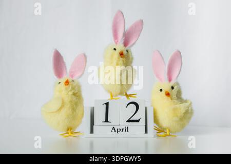 Christian Orthodox Easter 2026 date on a wooden calendar with three funny small Easter toy chicks on white background Stock Photo