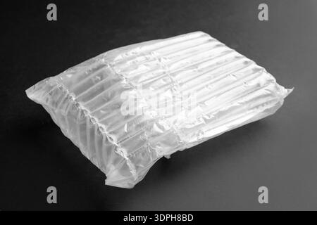 Transparent air buffer packaging on black background, closeup Stock Photo