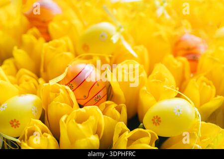 Spring festive composition with yellow tulips and decorative eggs Stock Photo