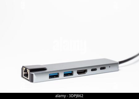 Premium gray aluminum USB-C multiport docking station featuring Gigabit Ethernet RJ45, 4K HDMI output, multiple USB-A ports, and flexible cable for wi Stock Photo