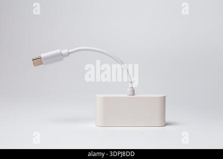 Close-up of white USB-C adapter with flexible cable and Type-C connector. Stock Photo