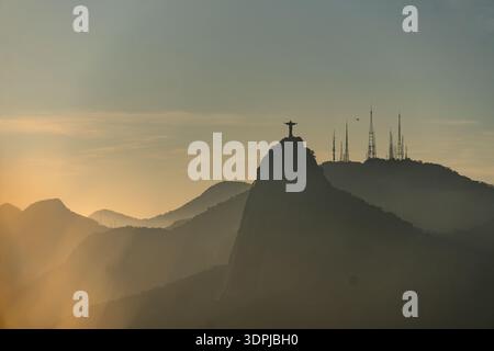 Rio de Janeiro, Brazil: Dramatic sunset over the iconic Christ the Redeemer statue in Rio de Janeiro in Brazil Stock Photo
